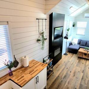 a room with a kitchen and a living room at NEW Nook Tiny Home with Deck Firepit Skylights in Apple Valley