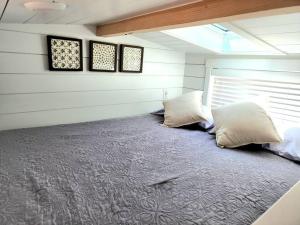 a room with two pillows on a bed in a house at NEW Nook Tiny Home with Deck Firepit Skylights in Apple Valley