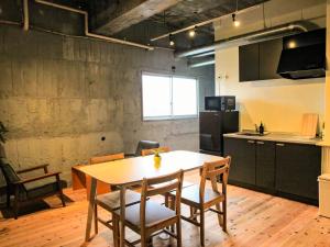 a kitchen and dining room with a table and chairs at 14 Guesthouse Mt.Fuji in Fuji