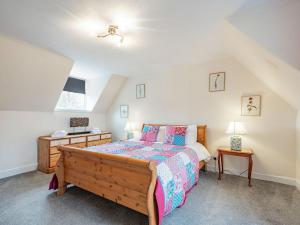 a bedroom with a large bed and a window at Black Grouse in Culter