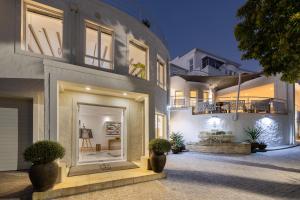 a large house with a door and a patio at Villa Afrikana Guest Suites by Knysna Paradise Collection in Knysna