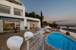 a house with a swimming pool and a patio at Villa Afrikana Guest Suites by Knysna Paradise Collection in Knysna