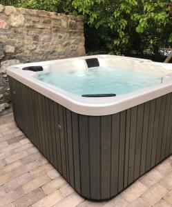 a large hot tub in a backyard with at Fügekert - Bed&Wine in Zánka