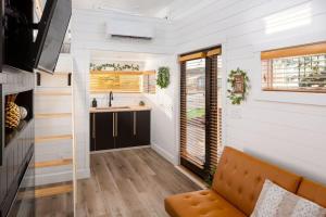 a tiny house with a kitchen and a couch at Zion Tiny Home, Private Hot Tub, Near Trails in Apple Valley +17 photos