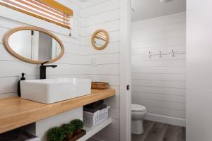 a bathroom with a sink and a mirror at Zion Tiny Home, Private Hot Tub, Near Trails in Apple Valley