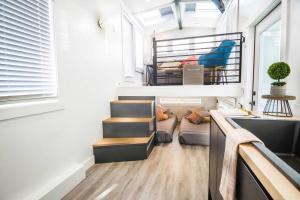 a tiny house with a staircase and a bunk bed at New modern & relaxing Tiny House w deck near ZION in Apple Valley
