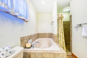 a bathroom with a tub and a shower at Stubbs Sanctuary in Spotsylvania +41 photos