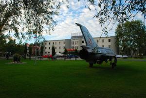 a small plane sitting on top of a grass field at Hotel Kosmonauty Wrocław-Airport in Wrocław