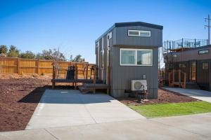a tiny house with a bench and a playground at Under The Sea Tiny Home in Apple Valley