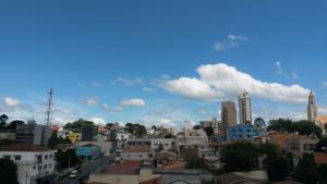 vistas a una ciudad con edificios y un cielo azul en Sokulski Flat Hotel e Restaurante, en Araucária