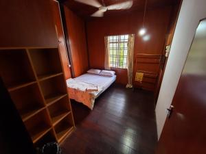 a small room with a bed and a window at Homestay Kuala Terengganu One Stop 1 in Kuala Terengganu