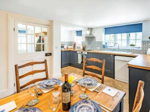 a kitchen with a wooden table with wine bottles at Lion Gate Lodge in Horncastle