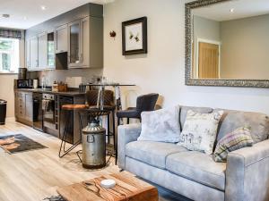 a living room with a couch and a kitchen at Beckett Lodge - Uk34233 in Barrowford