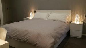 a bedroom with a large bed with two night stands at B&B Locanda Mediterranea in Naples