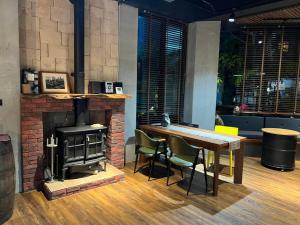 a room with a fireplace and a table and a wood stove at 木木宿宿MUMUsusu-stay只接待成年者一無包棟服務 in Taitung City