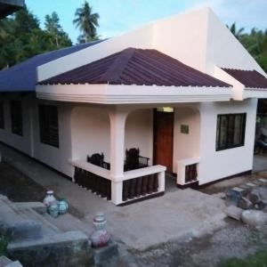 a small white house with a brown roof at ABIZA Homestay in Pañge