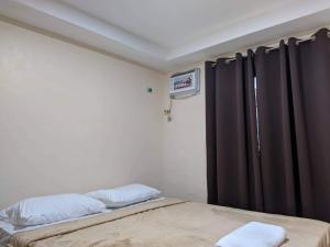 a bedroom with a bed and a window with black curtains at ABIZA Homestay in Pañge
