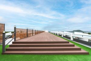 a boardwalk with stairs on top of a building at Hallim Resort in Jeju