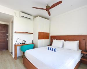 a bedroom with a bed and a ceiling fan at Bliss Dhigurah in Dhigurah