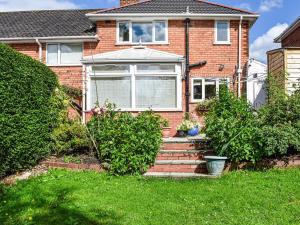 a brick house with stairs in the front yard at Serenity Comfort in Sutton Coldfield