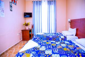 Postel nebo postele na pokoji v ubytování Iris Guest House