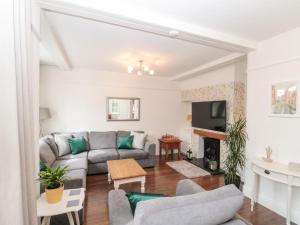 a living room with a couch and a fireplace at St Botolphs in Hornsea