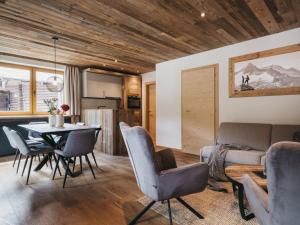 a dining room and kitchen with a table and chairs at VAYA Gerlos in Gerlos