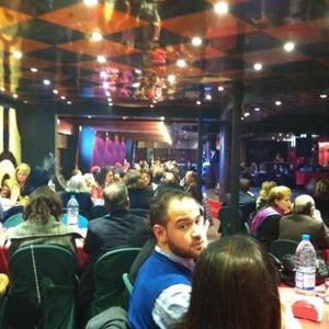 a crowd of people sitting in a room at HighLand Hotel in Aley