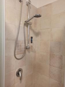a shower with a shower head in a bathroom at Trullo in piena valle d'itria del 1800 in Cisternino