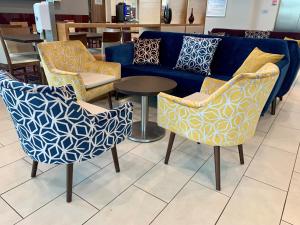 a blue couch and two chairs and a table at Days Inn Wetherby in Wetherby