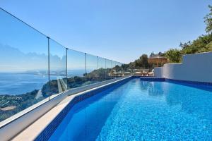 a swimming pool with a view of the ocean at Villa Omikron in Rodia