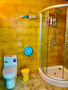 a bathroom with a toilet and a shower at See Sky at Na Rak O Resort in Chiang Rai