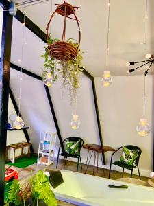 a room with chairs and a hanging plant at See Sky at Na Rak O Resort in Chiang Rai