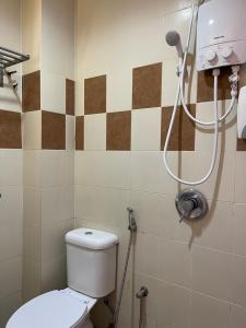 a bathroom with a toilet and a shower at Fresh Hotel in Ipoh