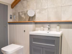 a bathroom with a sink and a toilet at Pilgrims Barn in Hitcham