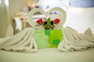 two white swans with a flower in a box at Grandmas Plus Hotel Seminyak in Seminyak