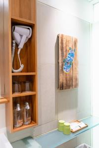 a kitchen with a phone in a cabinet at Grandmas Plus Hotel Seminyak in Seminyak