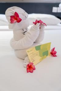 a stuffed animal wearing a chef hat and flowers at Grandmas Plus Hotel Seminyak in Seminyak