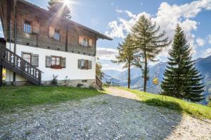 a house on a hill with mountains in the background at Bergchalet Schennaberg in Schenna