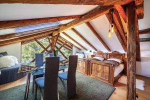 a bedroom with a bed and a table and chairs at Bergchalet Schennaberg in Schenna