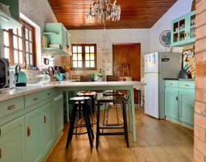 a kitchen with green cabinets and a white refrigerator at Casa do Paço Aveiro - HolidayHome in Aveiro