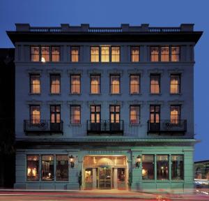 a large building with many windows at night at Market Pavilion Hotel in Charleston