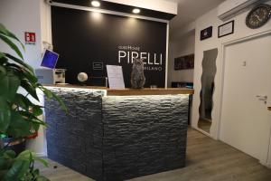 a black stone counter with a cat statue on top of it at Guest House Pirelli Milano in Milan