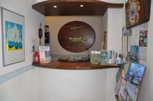 a shelf on a wall with a picture of a boat at Hotel Villa La Marticana in Ischia