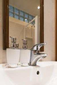 a bathroom sink with a chrome faucet at Angeles Inn in Venice