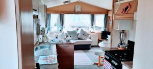 a kitchen and a living room with a caravan at Bayview Brixham in Brixham