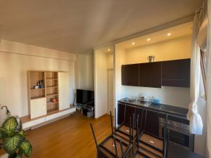 a kitchen with black cabinets and a living room at Arco della Pace Corso Sempione 12 in Milan +9 photos