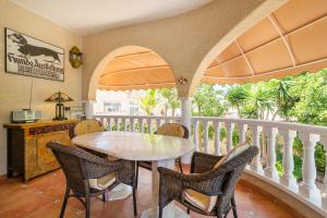 a dining room with a table and chairs on a balcony at Villa Mopsi in Ciudad Quesada