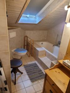 a bathroom with a tub and a toilet and a sink at Ferienwohnung Trina in Bendorf
