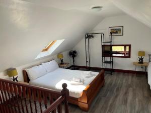 a bedroom with a bed on a balcony at Merrick Cottage in Bargrennan